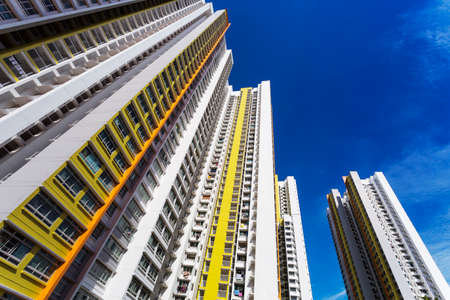 A low angle shot of a new colorful high rise apartment against the sky 
