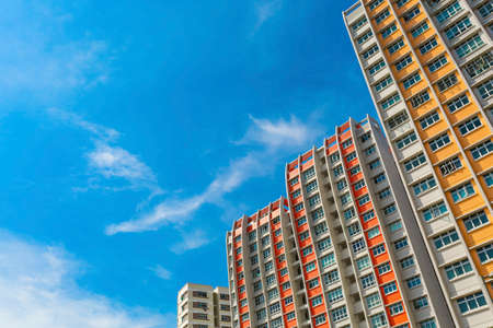 A low angle shot of a new colorful high rise apartment against the sky の写真素材