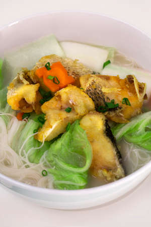 Rice noodles bee hoon noodles soup with fried fishの写真素材