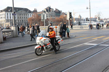 Zurich, Switzerland - November 26, 2011. A police officer on a motorcycle accompanying the demo