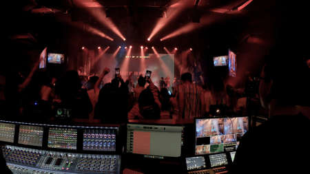 Christian concert foh with lights, view from the sound console and lights consoleの写真素材