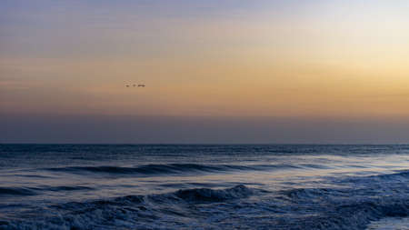 Edge of the Colombian sea with sunset on one sideの写真素材