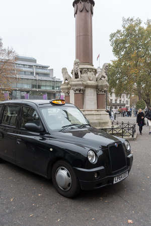 LONDON, UNITED KINGDOM - NOVEMBER 23, 2018: Taxi black cab near Crimea and Indian Mutiny memorialのeditorial素材
