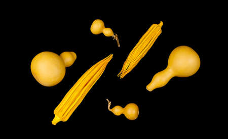 Yellow okra and bottle shaped chinese gourds Hu Lu on black background