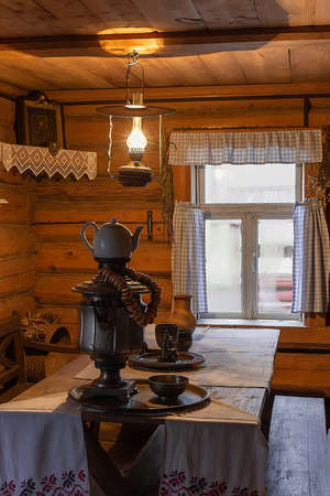 Interior of russian traditional wooden house with russian kettle Samovar. Traditional Russian Still...