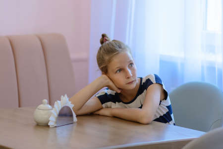 Dreamy teen girl boring in the cafeの写真素材