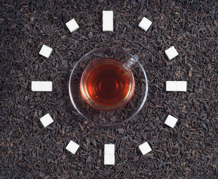 Cup of tea clock with sugar in the afternoonの写真素材
