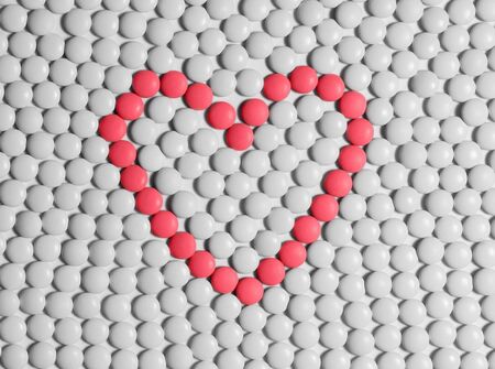 Heart made of red pills on a background of white pills