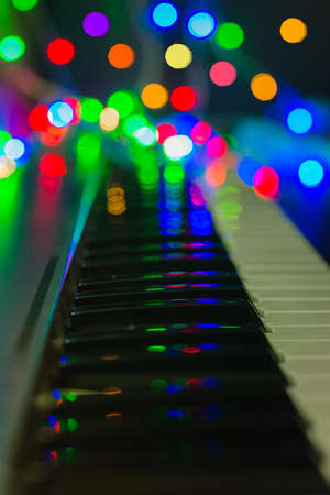 piano keys close-up, blurred background, colorful bokeh, musical instruments, new year, Christmas, Christmas concertの写真素材