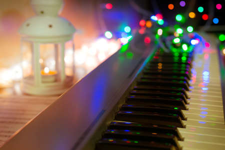 synthesizer, piano, piano keys close-up, blurred background, colorful bokeh, musical instruments, new year, Christmas, Christmas concertの写真素材