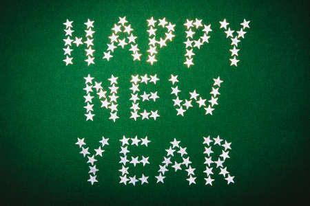 the inscription the stars of a happy new year on a green background, a Christmas backgroundの写真素材