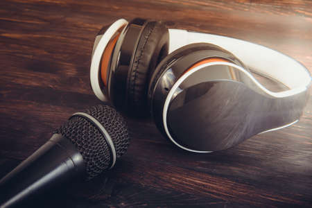 a microphone and headphones on a wooden backgroundの写真素材