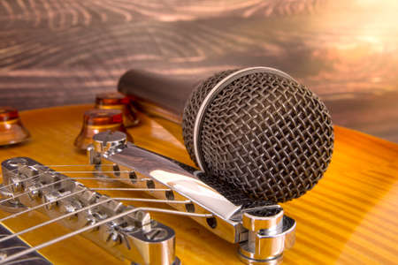 black microphone and yellow guitarの写真素材