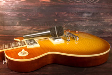 electric guitar and microphone on wooden backgroundの写真素材