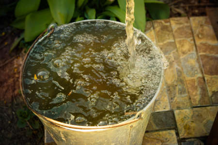 water flows into the bucketの写真素材