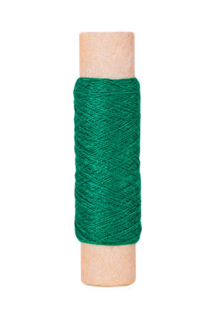 Dark green sewing thread reel on white isolated backgroundの写真素材