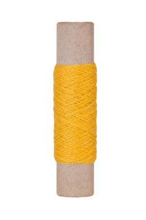 Yellow sewing thread reel on white isolated background
