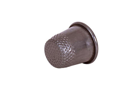 Thimble on finger on white background