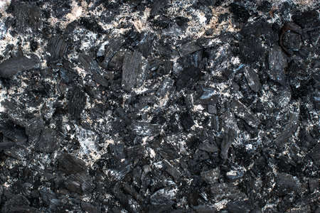 black charred coals closeup, background of coals
