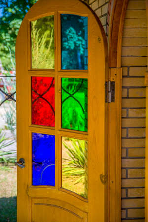 An open door with colored glass. Open the front door.の写真素材