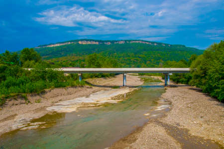 Bridge over the mountain river on the background of mountains