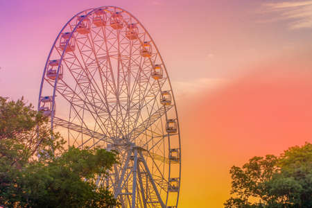 Large Ferris wheel against a beautiful sunset sky.の写真素材