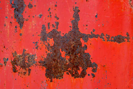 Texture of rusty metal with peeling red paint