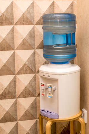 A cooler with a bottle of water is in the cornerの写真素材