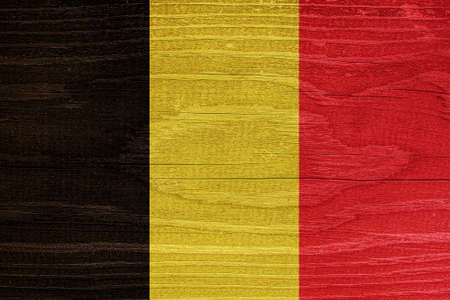 The Belgian flag with the texture of wood. Flag of Belgium on a wooden textureの写真素材