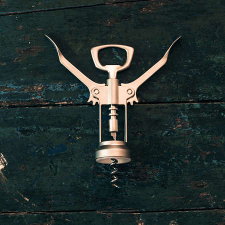 Metal corkscrew for on dark wood surface