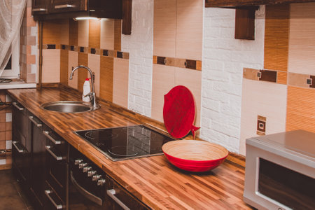 The interior of a modern kitchen. Sink, electric stove in the kitchenの写真素材