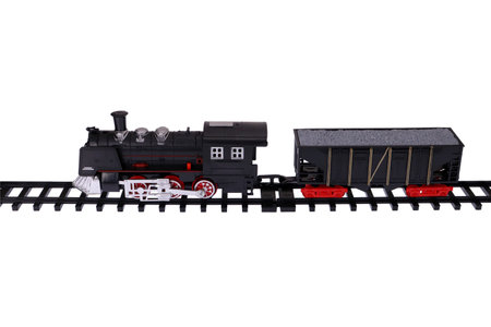 A steam locomotive and a car on the rails. Toy train on a white background, isolated imageの写真素材