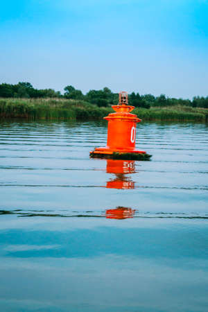 A red buoy on the waves of the river. River navigationの写真素材