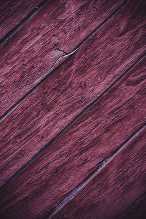 The background is made of old cracked boards of burgundy color.の写真素材