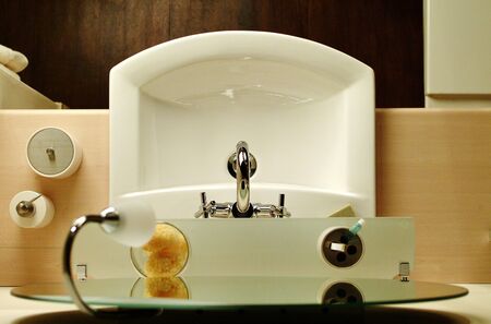Top view of a sink with faucet on blue tiled bathroom