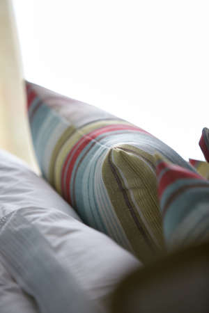 Close-up of multicolored striped pattern pillows on a sofa in living room