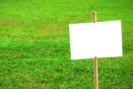 Blank empty white sign on green grass backgroundの写真素材