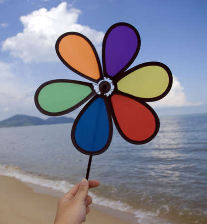 Wind wheel at beach with cloudy sky の写真素材