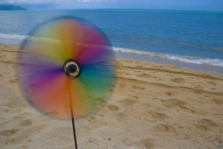 Spinning wind wheel at the beachの写真素材