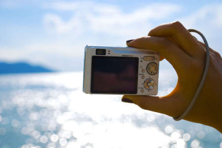 Hand photographing beach - summerの写真素材
