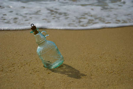 Message in bottle lying on beachの写真素材