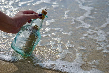 Picking up message in the bottleの写真素材