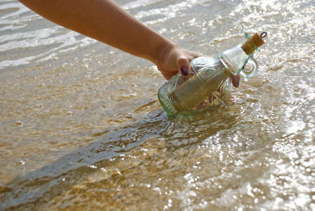 Picking up message in the bottleの写真素材