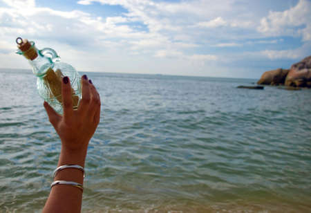 Throwing bottle into the seaの写真素材