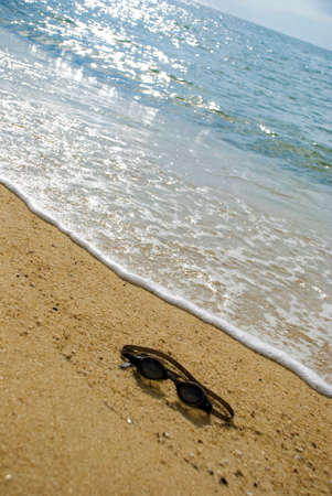 Goggle on beach - drown concept