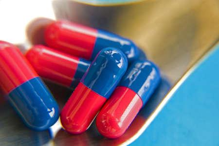 Red-Blue tablets on spoonの写真素材