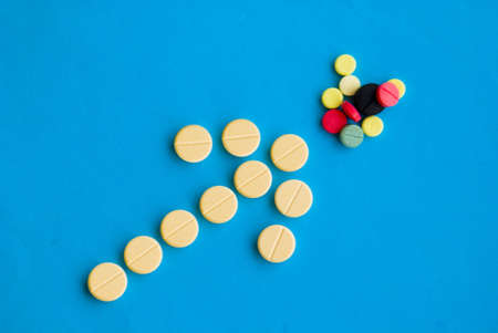 Arrow pointing at various medical pillsの写真素材