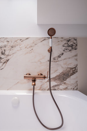 a bathtub with a shower head attached to itの写真素材