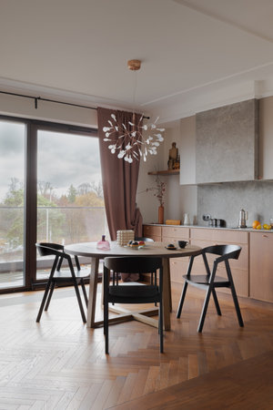 Building with table, chairs, large window, hardwood flooringの写真素材