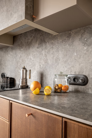 Kitchen counter with jar of oranges and lemons on wood countertopの写真素材